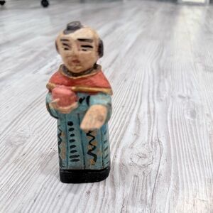 Hand-Painted Figurine with Red and Blue Accents